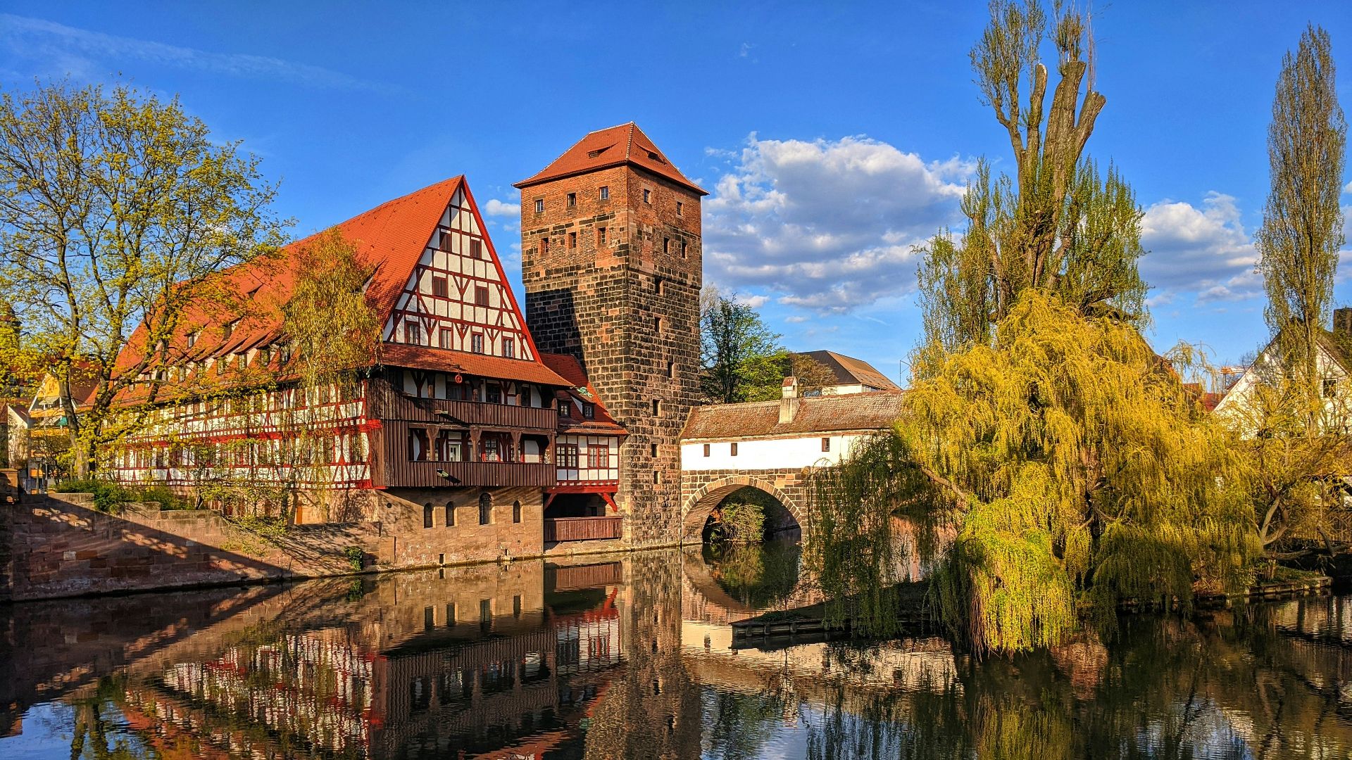 brown brick building near body of water during daytime