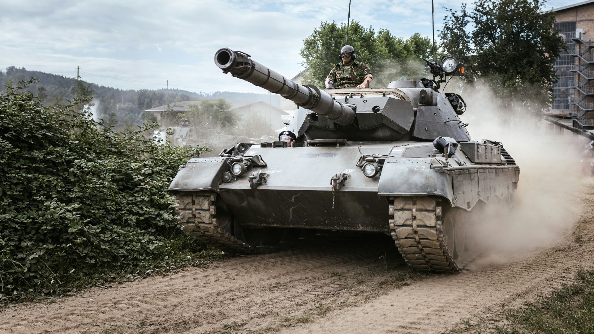 battle tank on green grass field during daytime