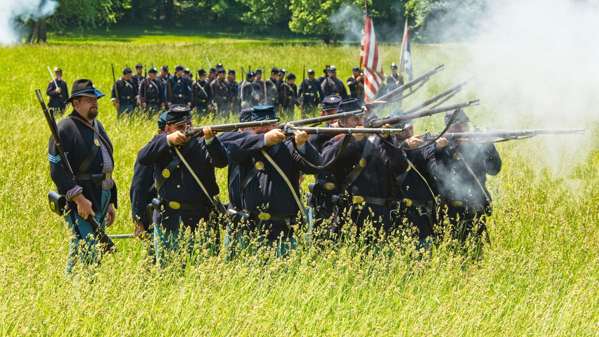 people in black uniform standing on green grass field during daytime