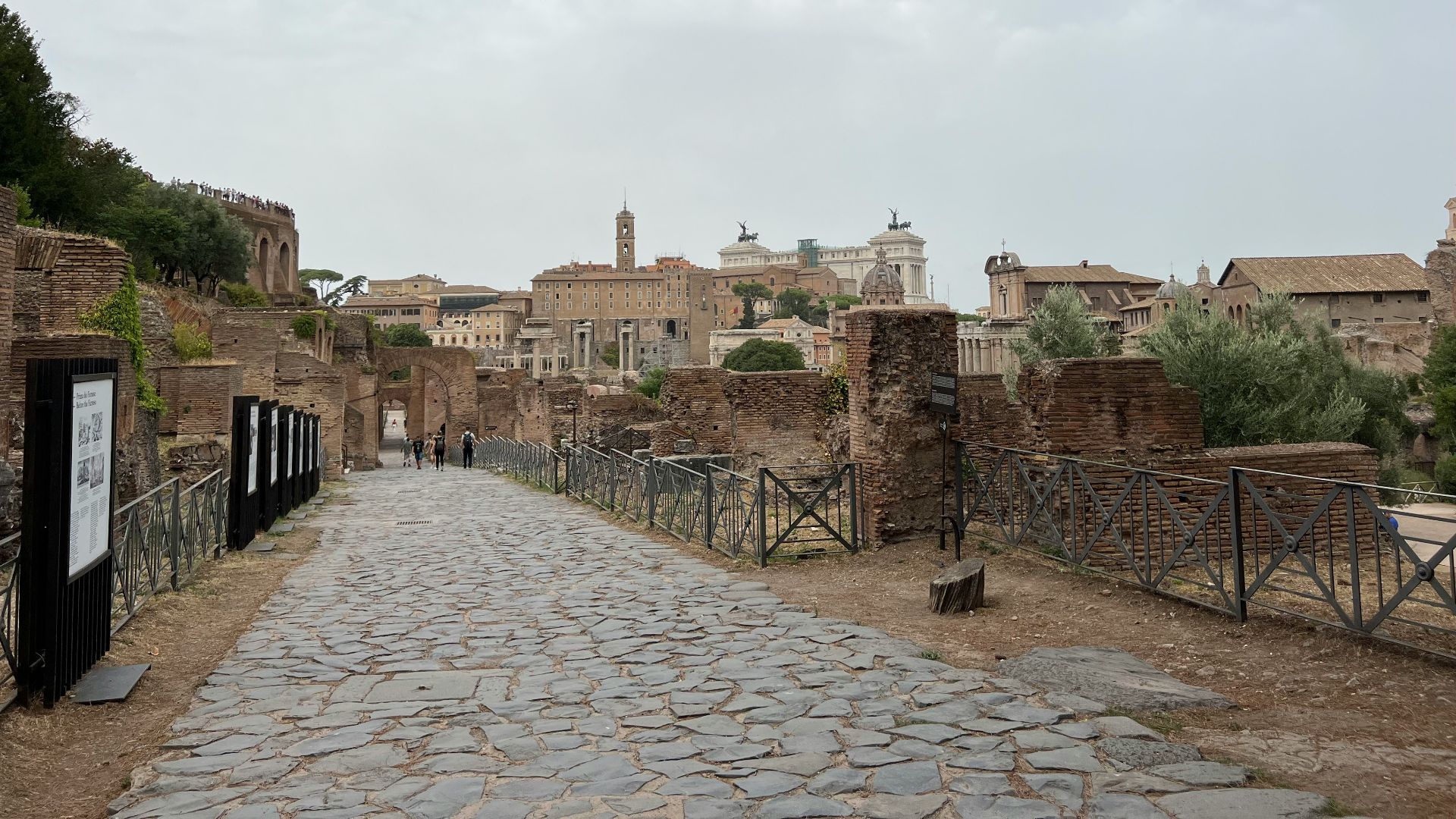 a stone walkway leading to a city