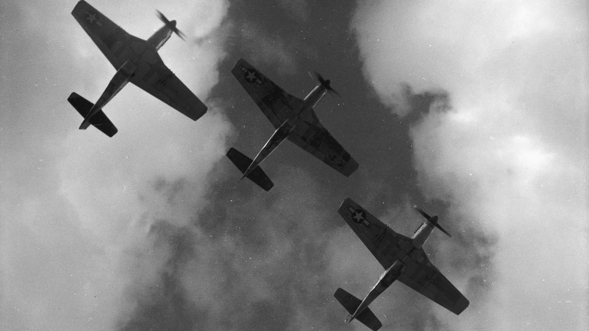Four P-51 Mustangs flying in formation