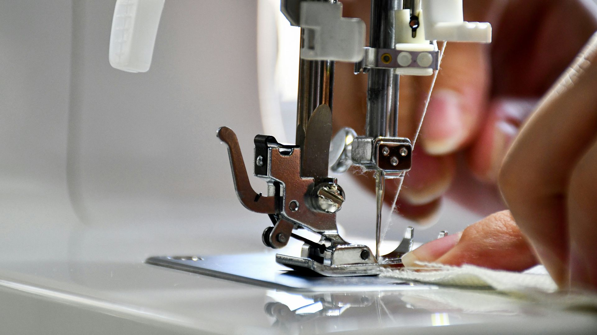 person using sewing machine in tilt shift lens