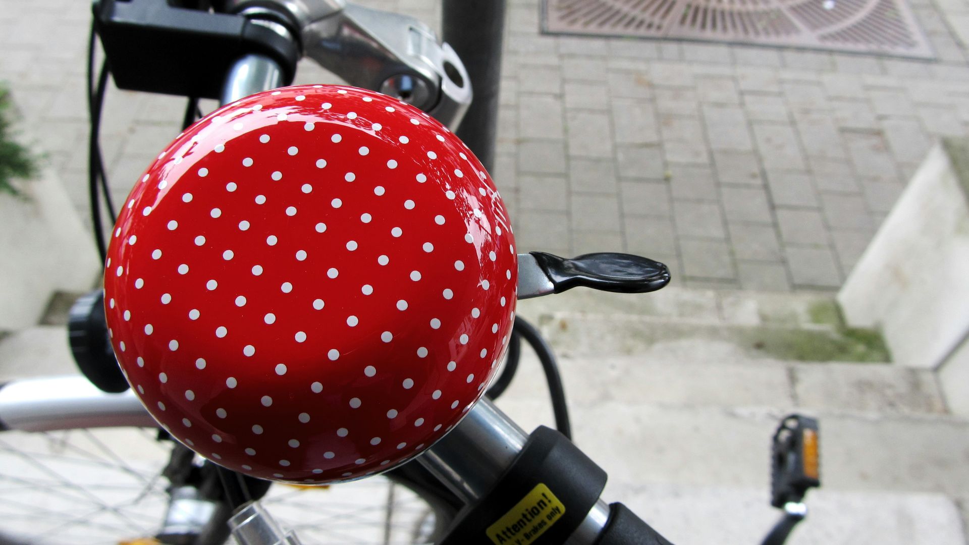 A close up of a red and white polka dot ball on a bike