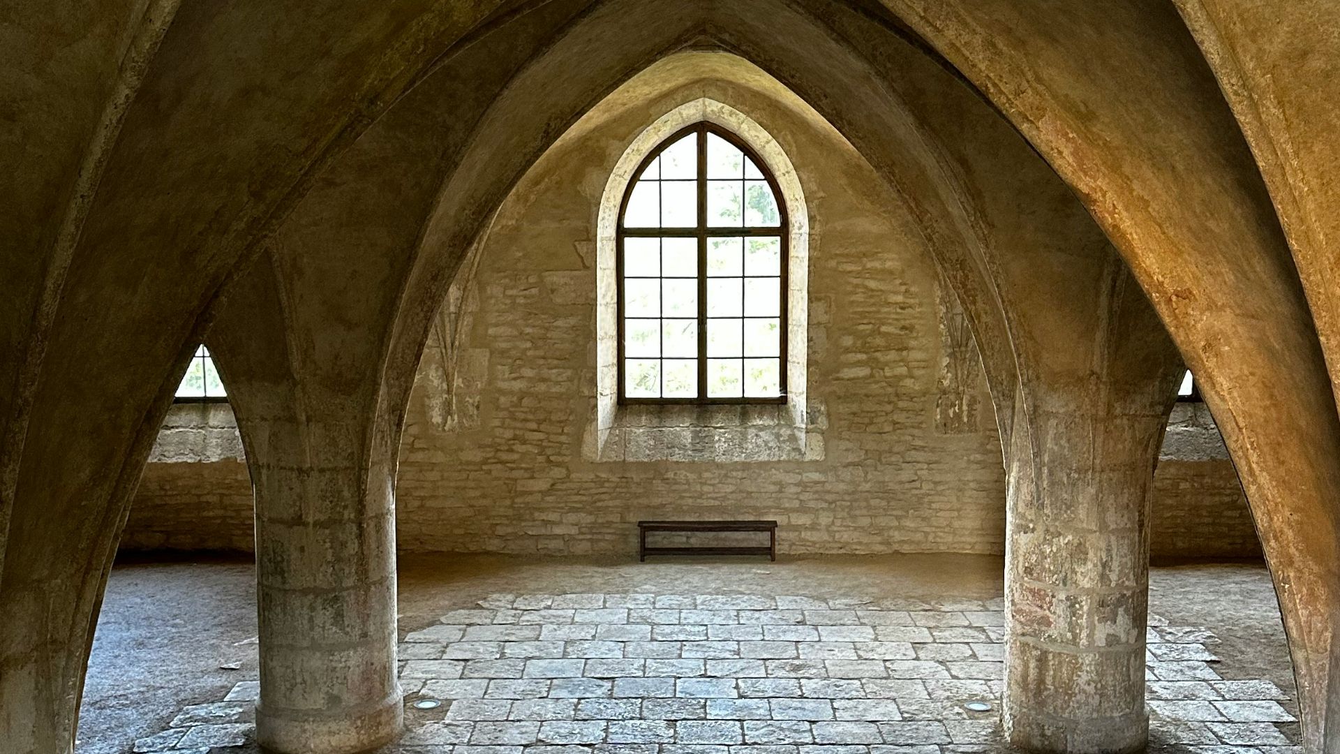 a stone building with a staircase leading up to a window