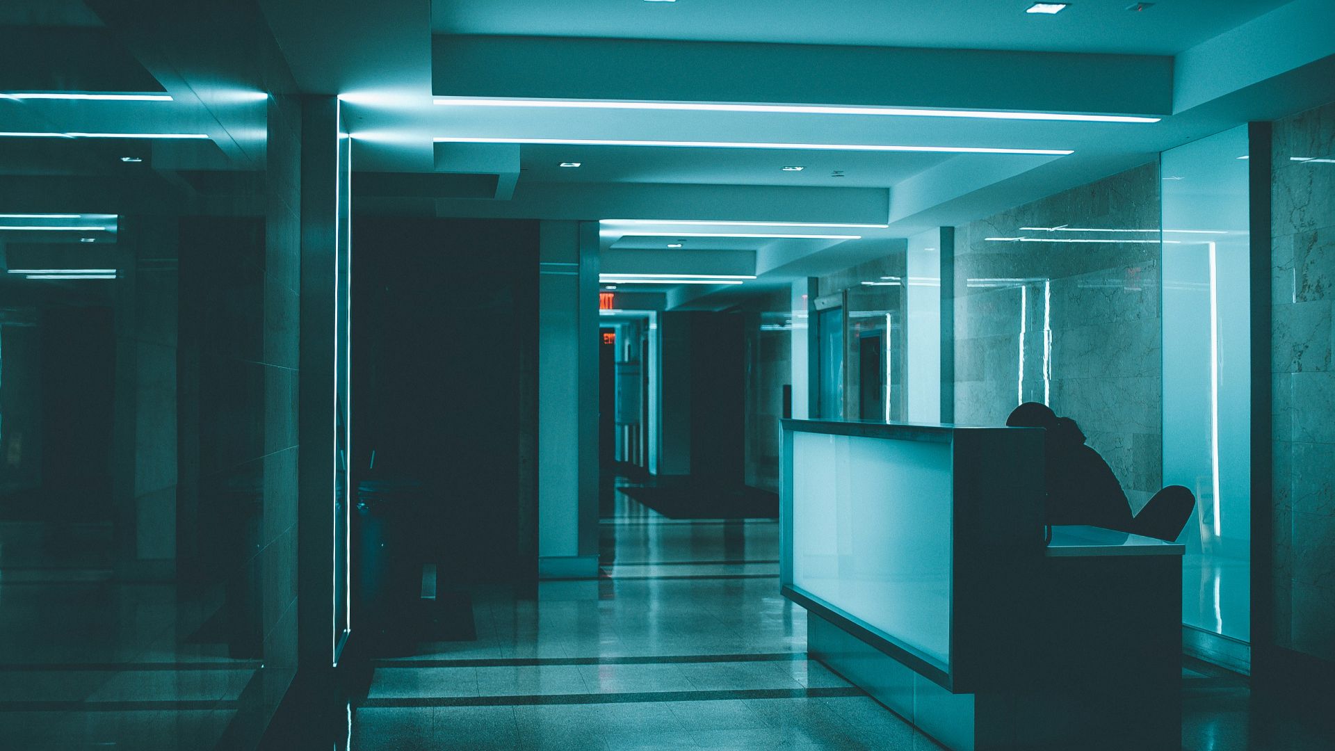 white wooden desk on hallway inside building