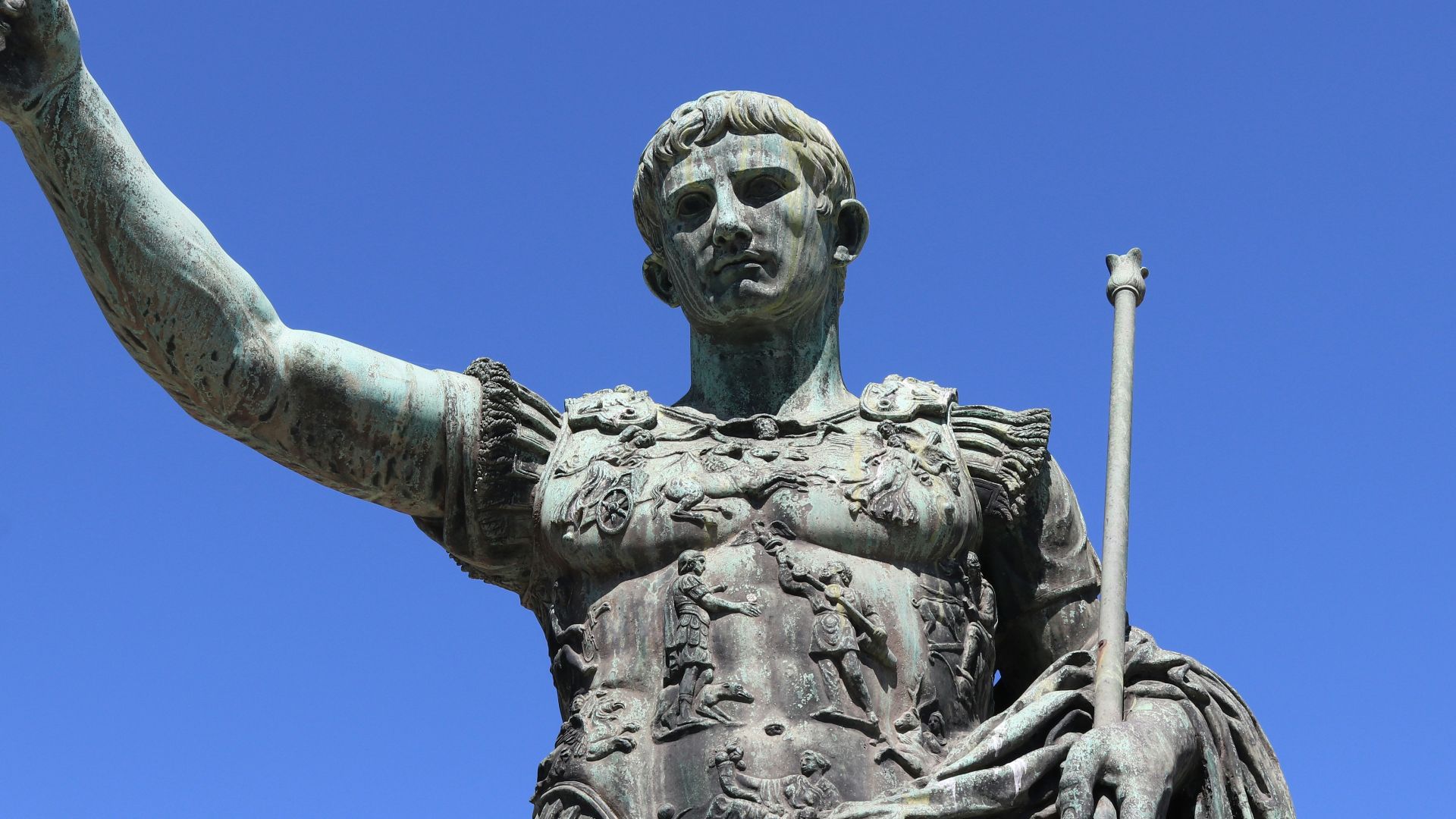 a statue of a person holding a staff