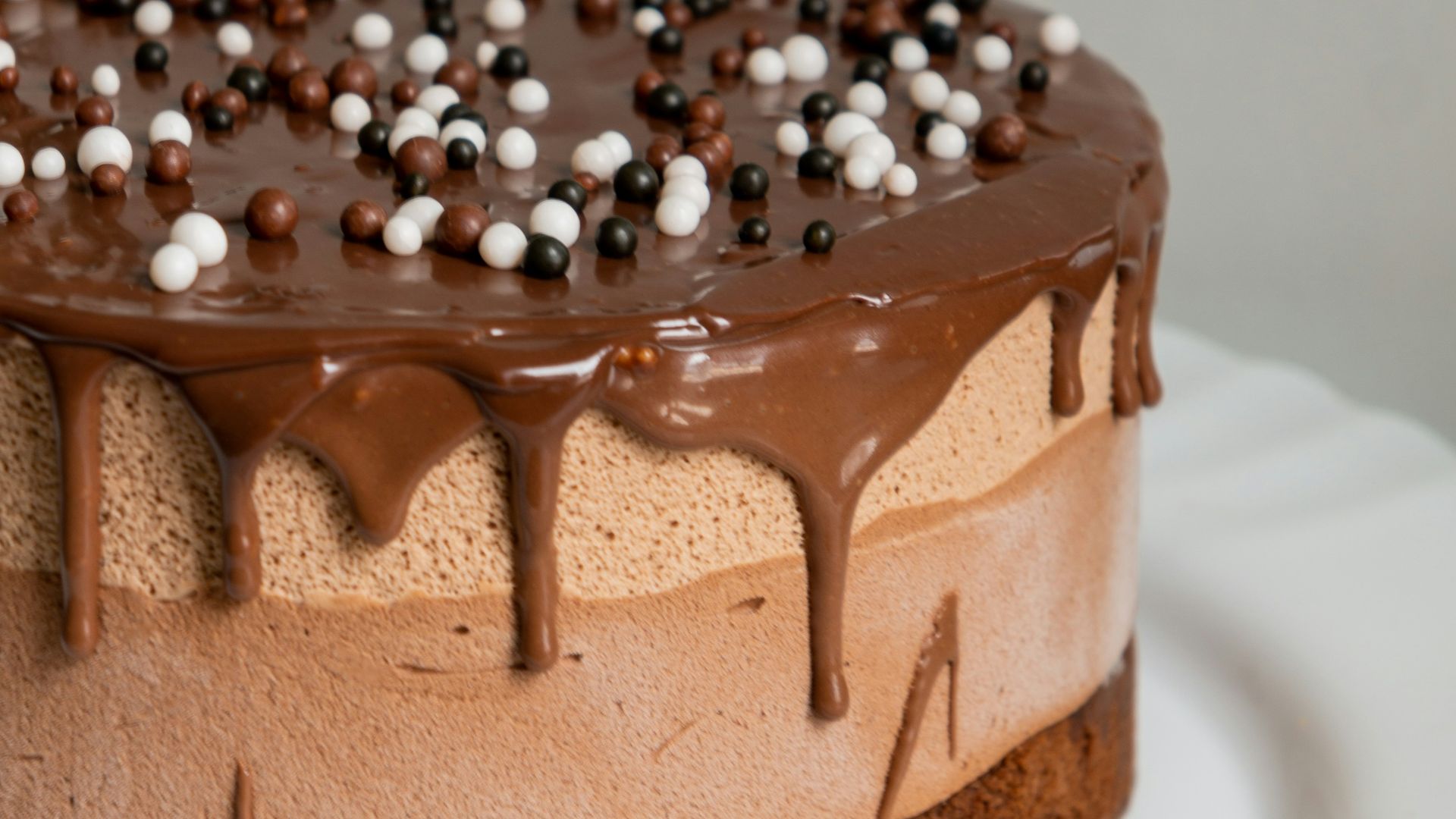chocolate cake with white icing on white ceramic plate