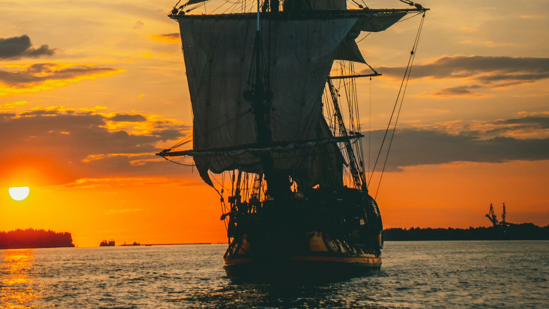 silhouette of ship on sea during sunset