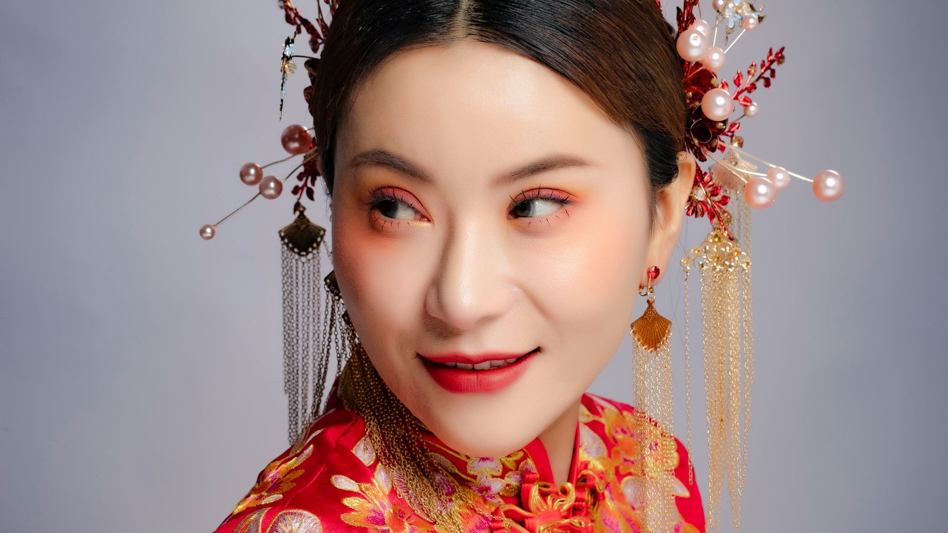 a woman in a red dress with a flower in her hair