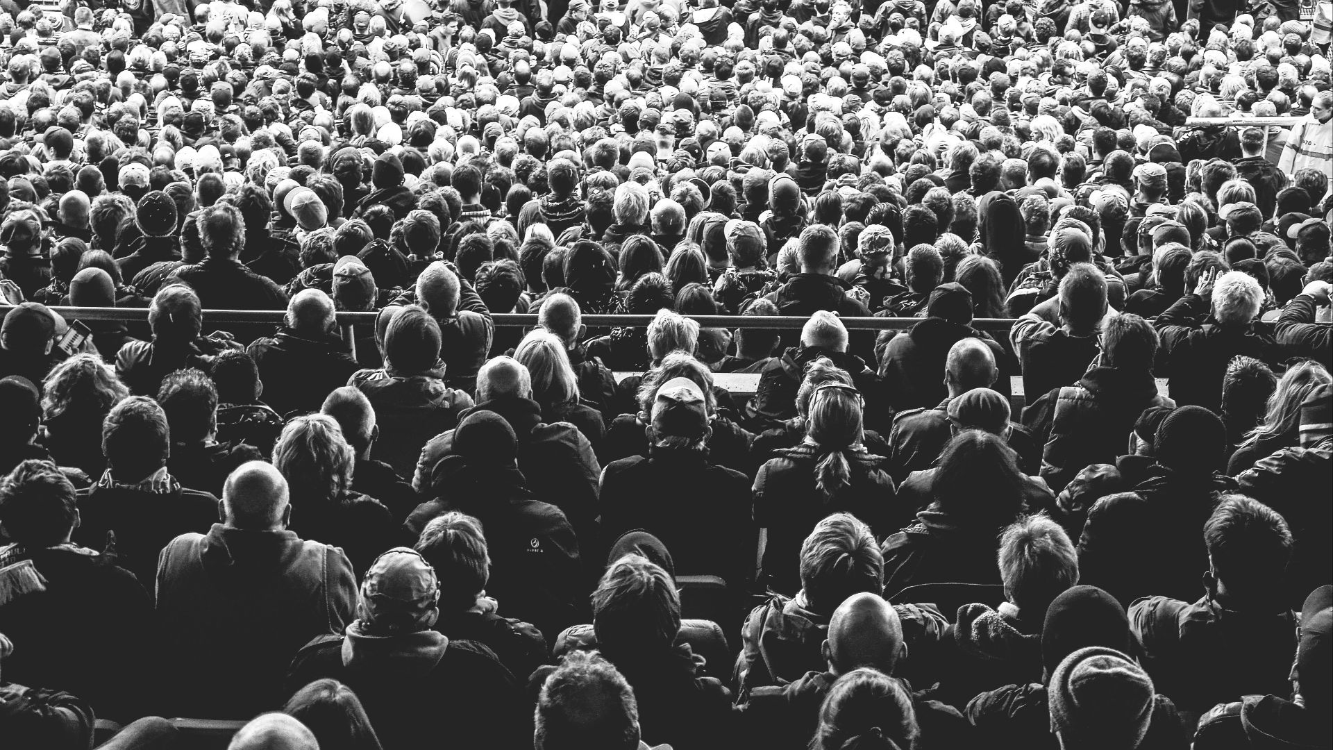 grayscale photo of people sitting on chair