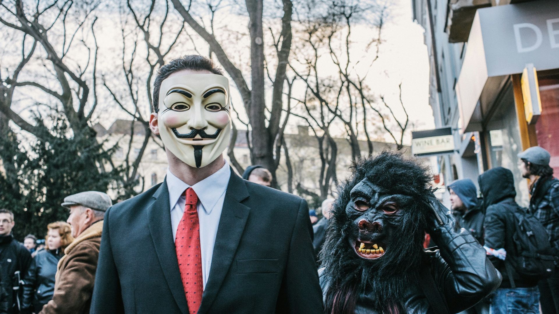 man in black suit jacket wearing black and white mask