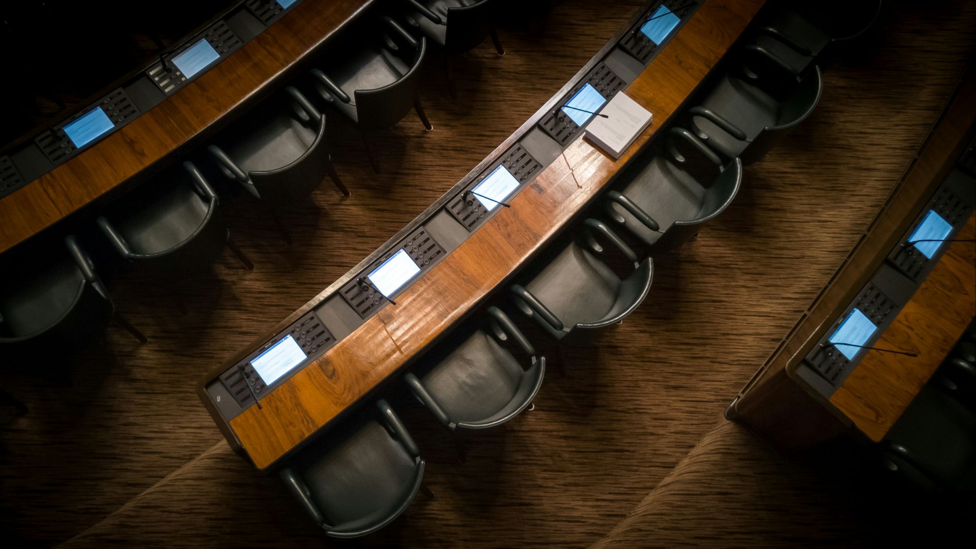 low light photography of armchairs in front of desk