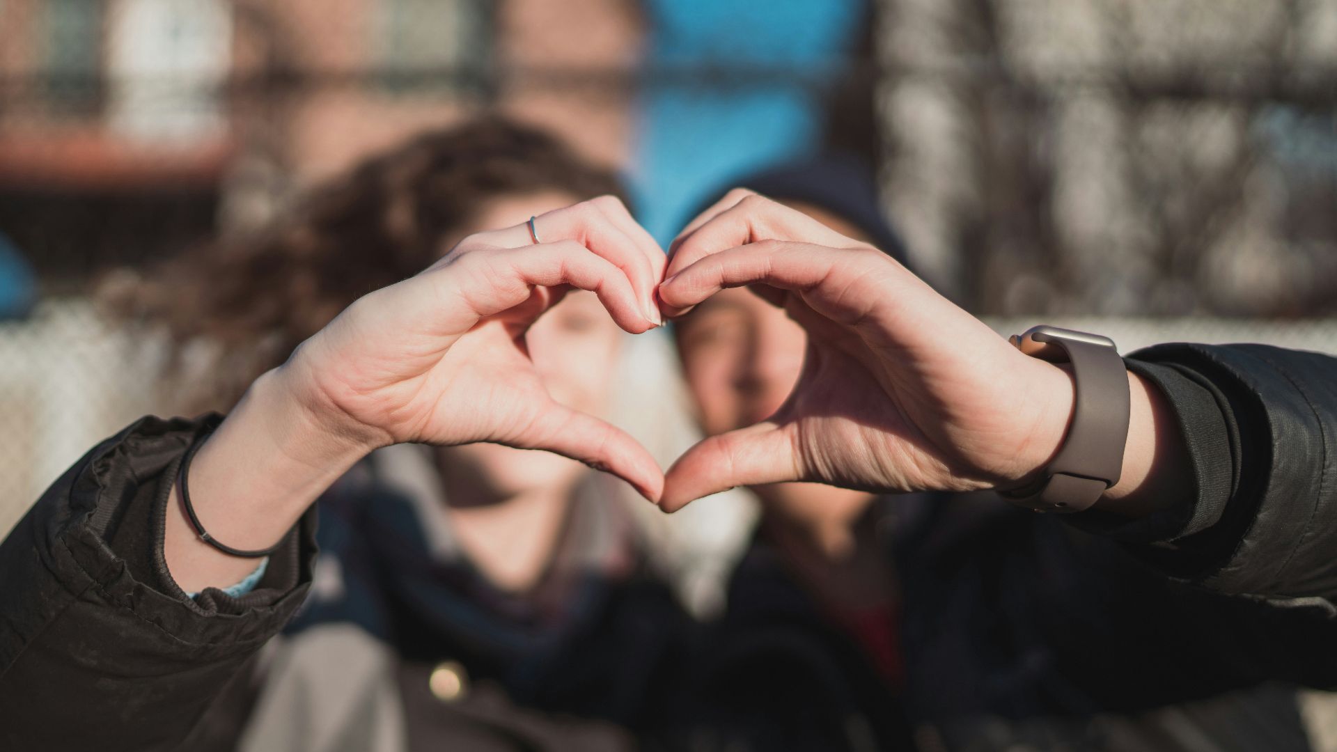 two person combine hand forming a heart hand gesture