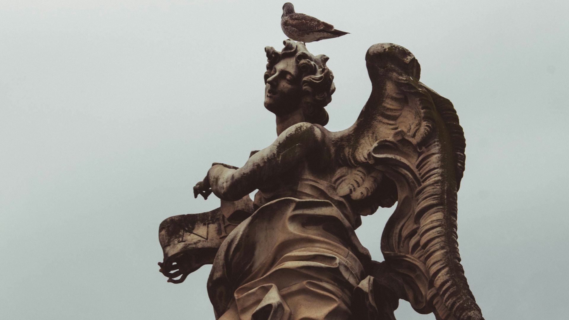 a statue with a bird on top of it