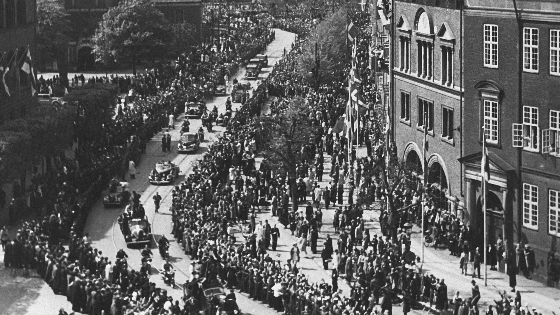 a crowd of people standing on top of a street