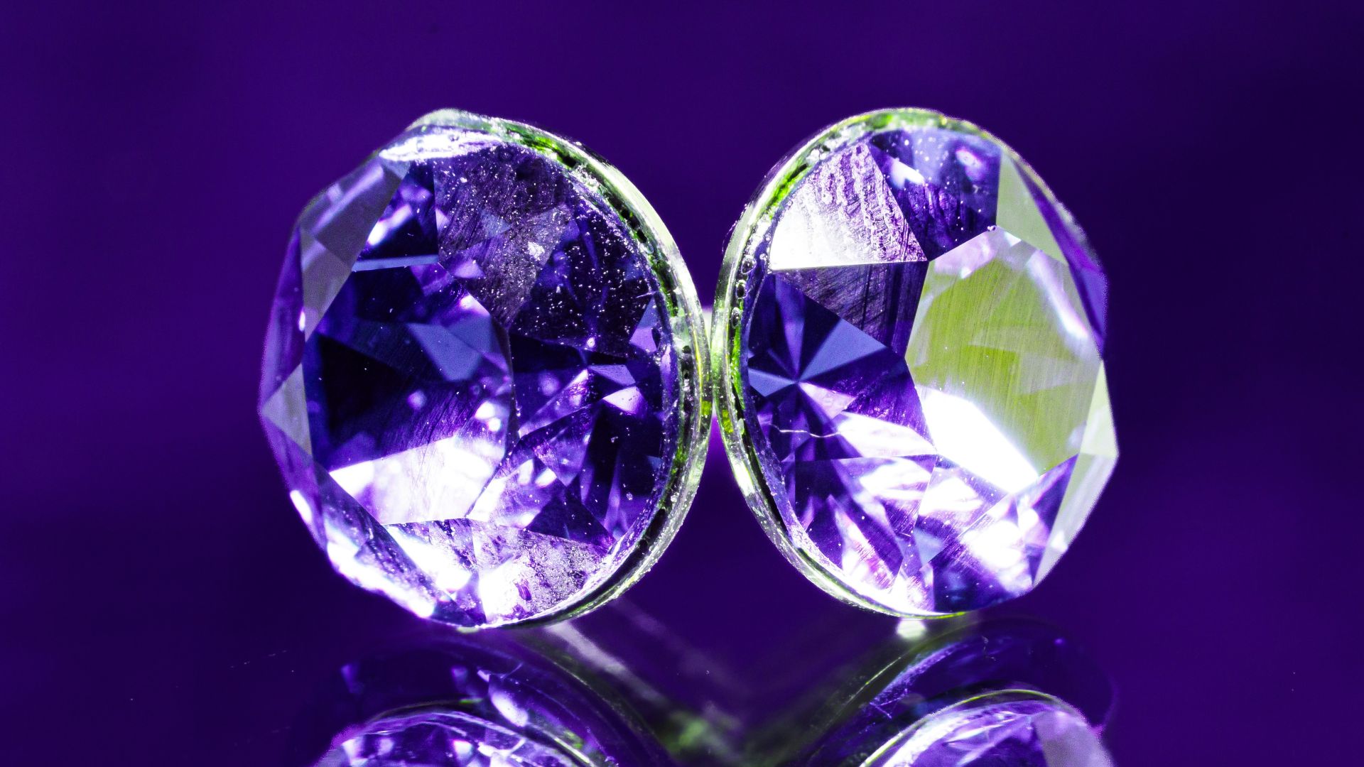A pair of purple diamonds sitting on top of a table
