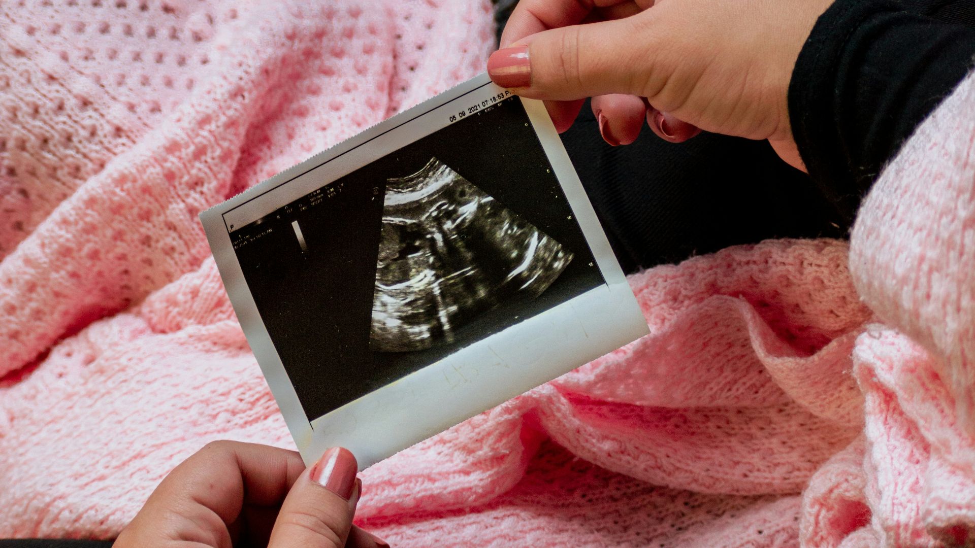a person is holding a picture of a baby