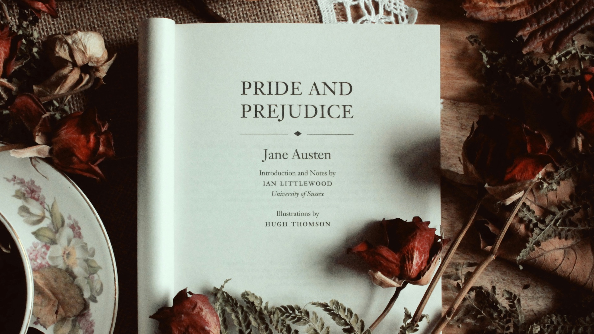 a book sitting on top of a table next to a cup of tea