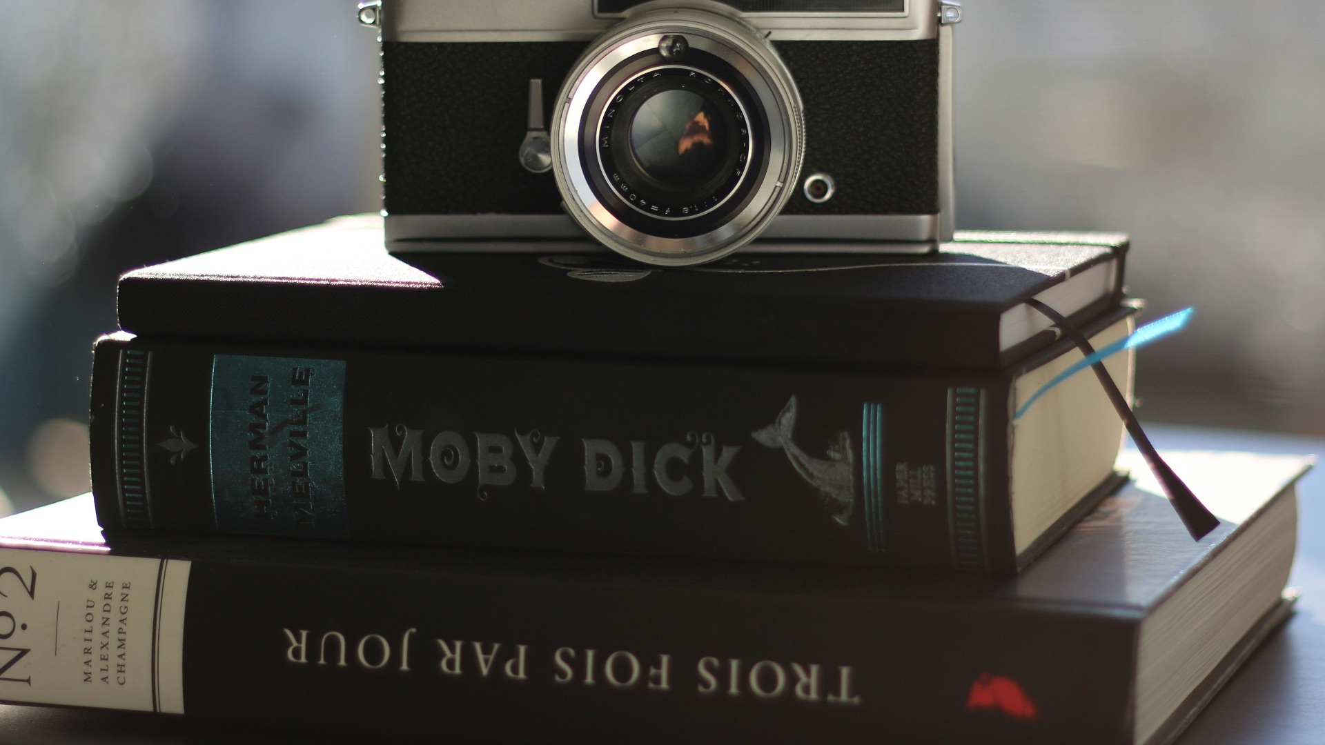 a camera sitting on top of a stack of books