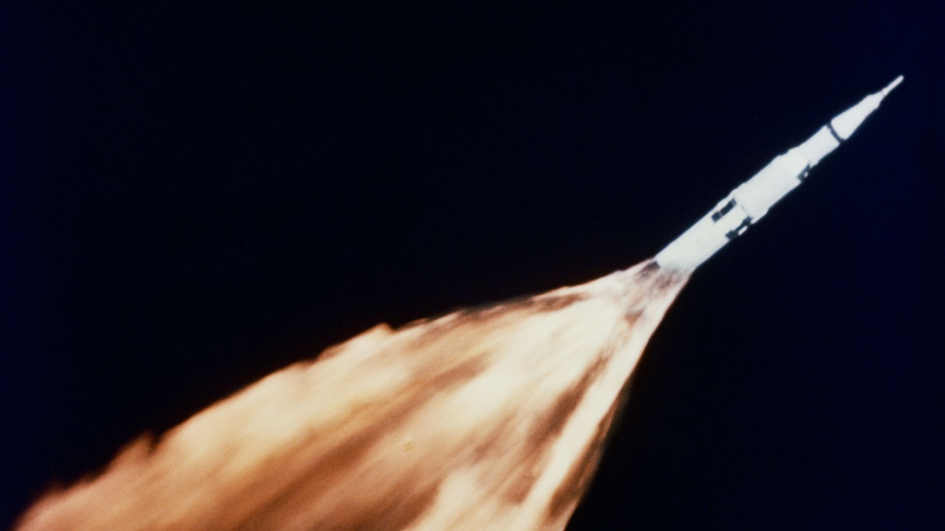 Saturn rocket with a trail of flames during launch