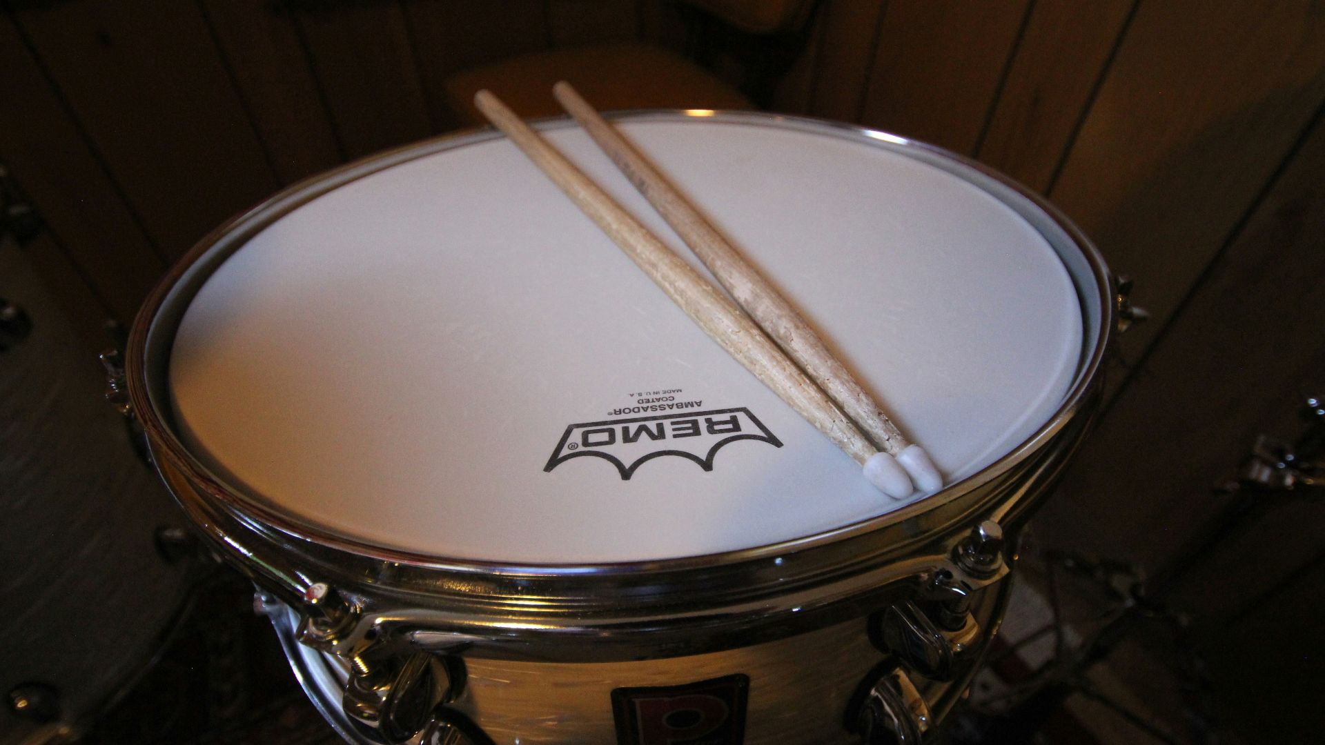 a close up of a drum with two sticks sticking out of it