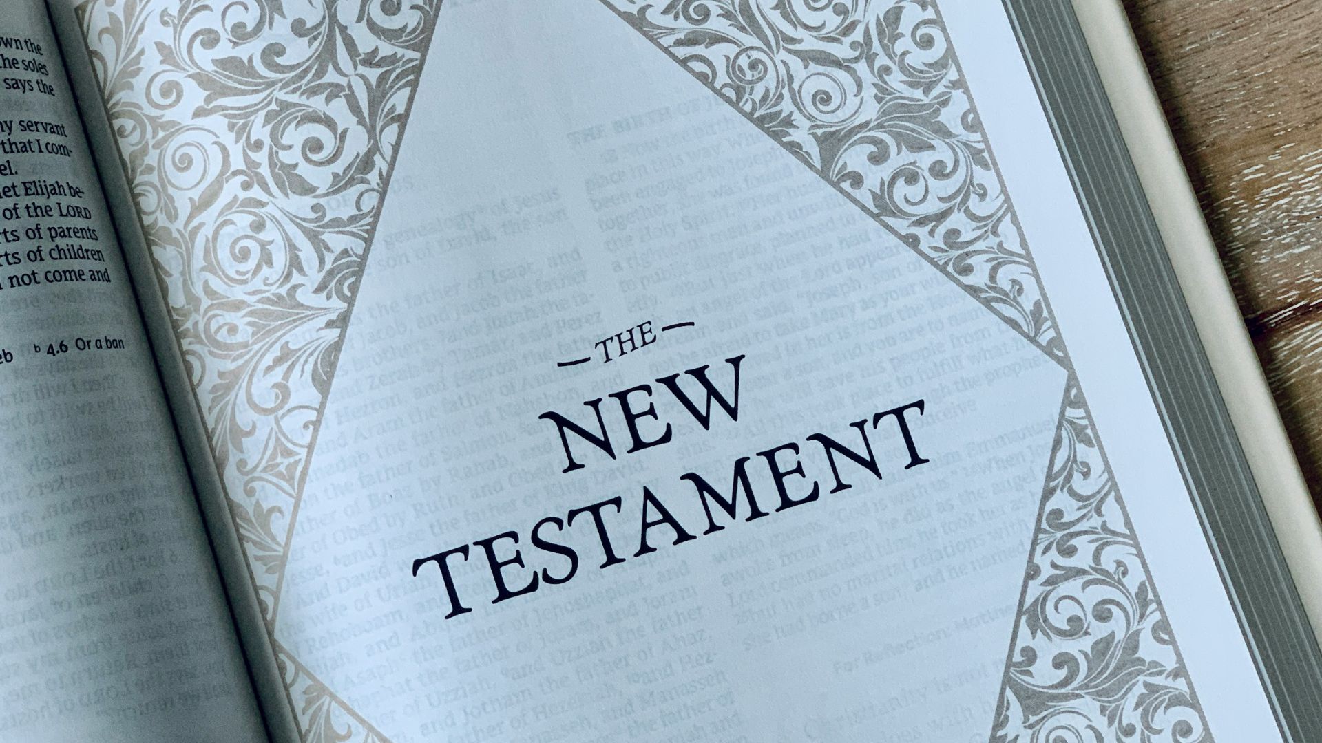 an open bible on a wooden table