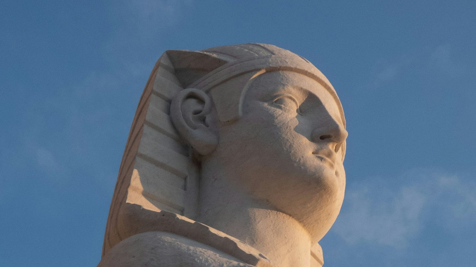 a statue of a sphinx on top of a building