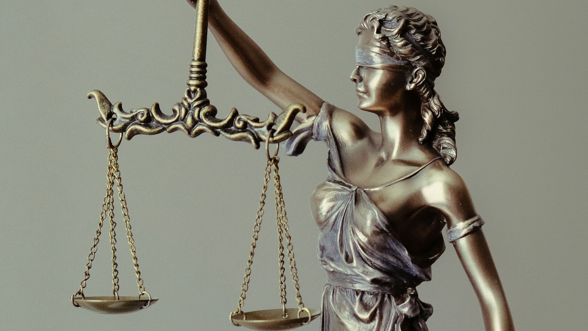 woman in gold dress holding sword figurine