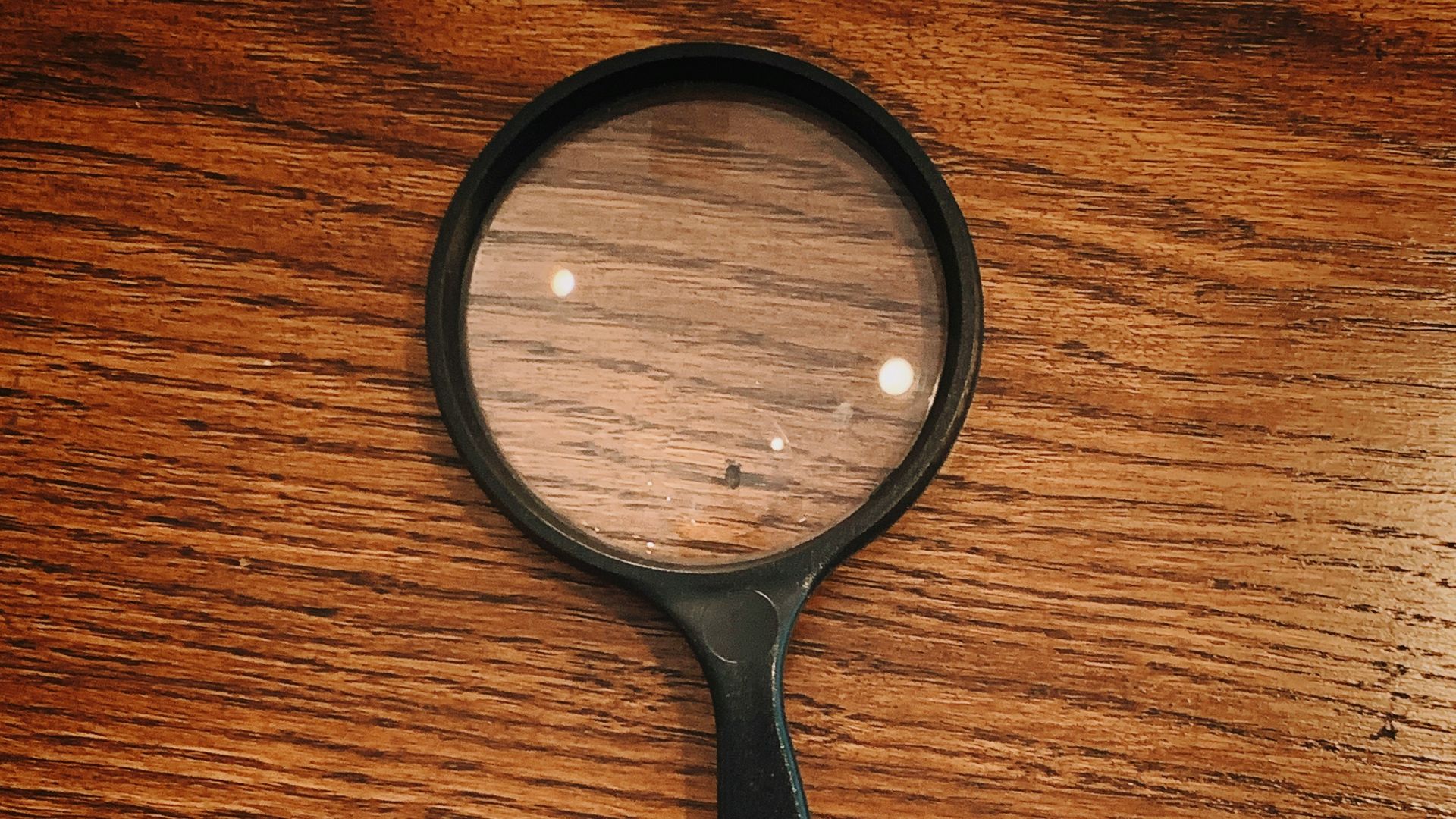black framed magnifying glass