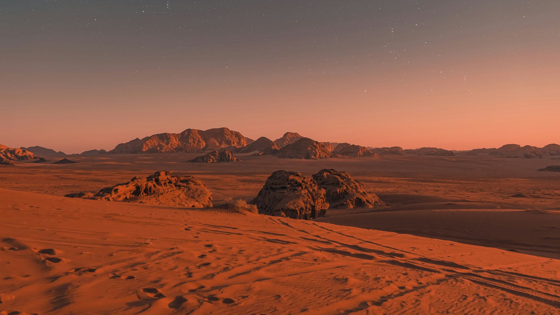 brown sand under blue sky during night time
