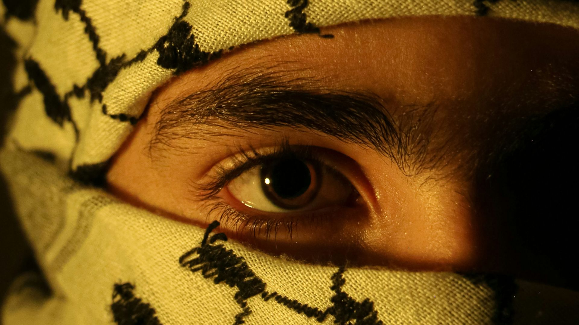 A man wearing a yellow and black patterned mask