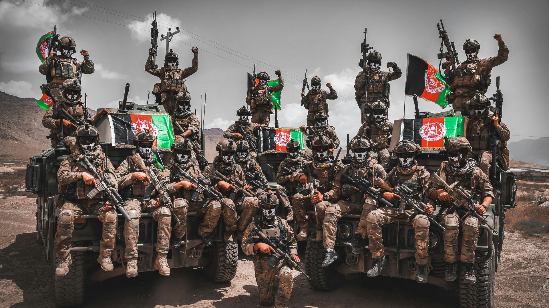a group of military men riding on the back of a truck