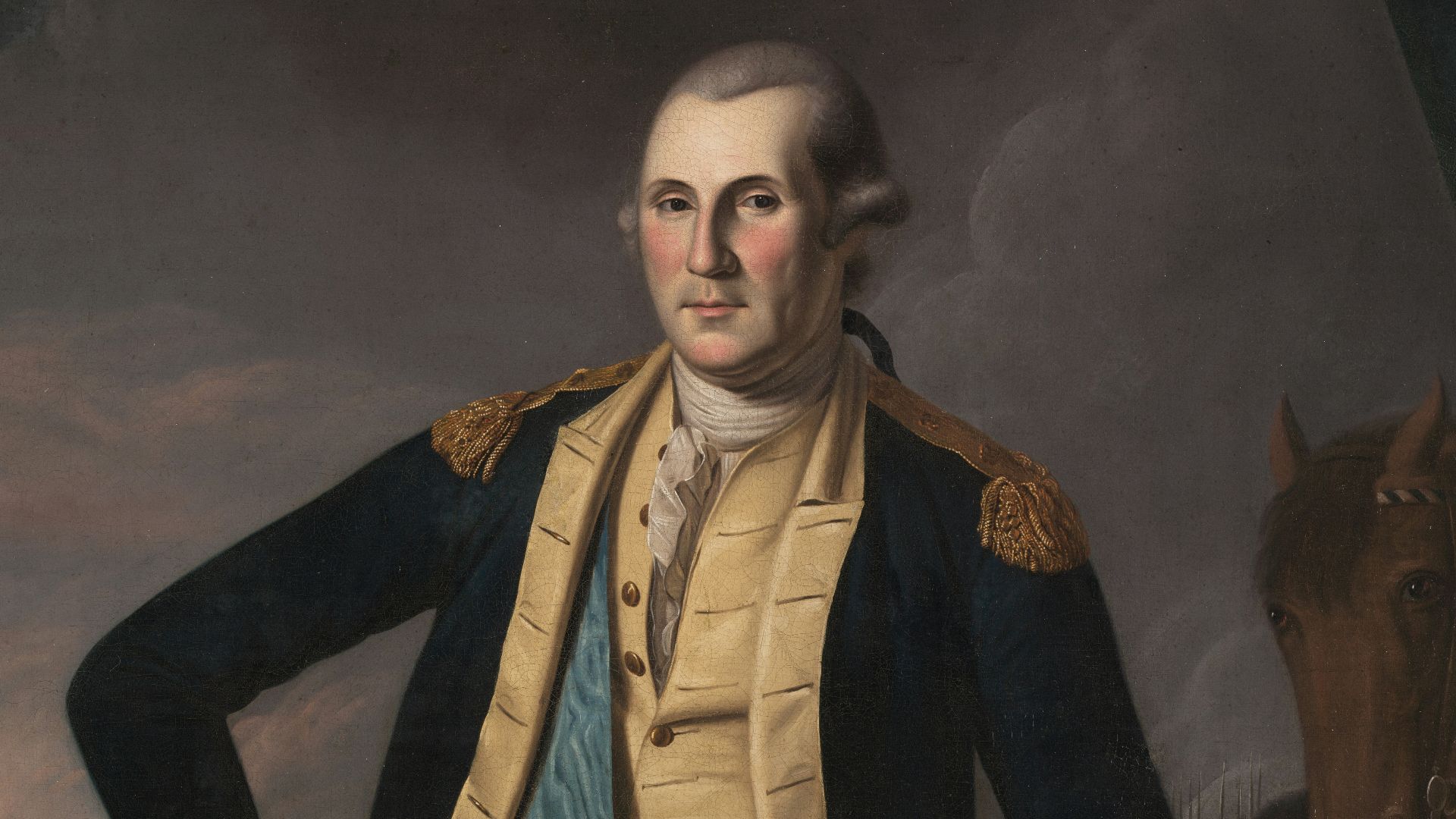 George washington in military uniform with cannon.