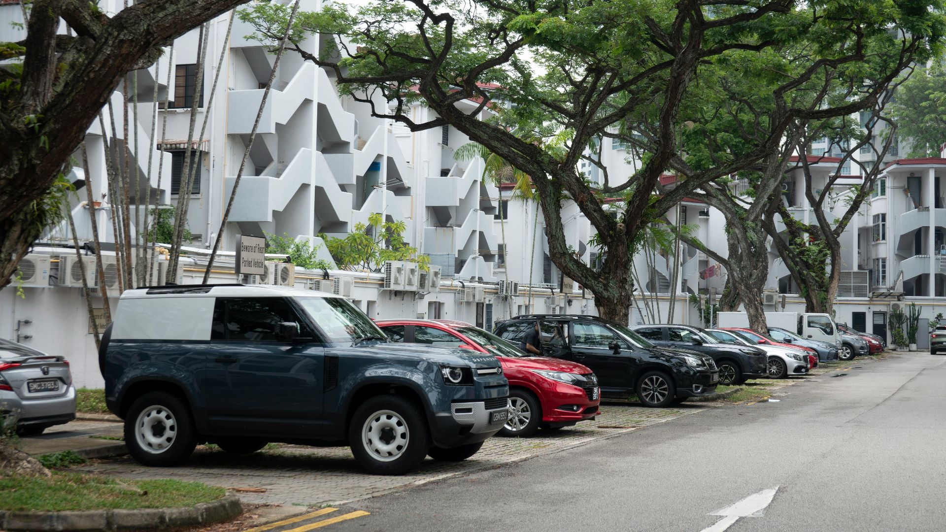 a row of cars parked on the side of a street