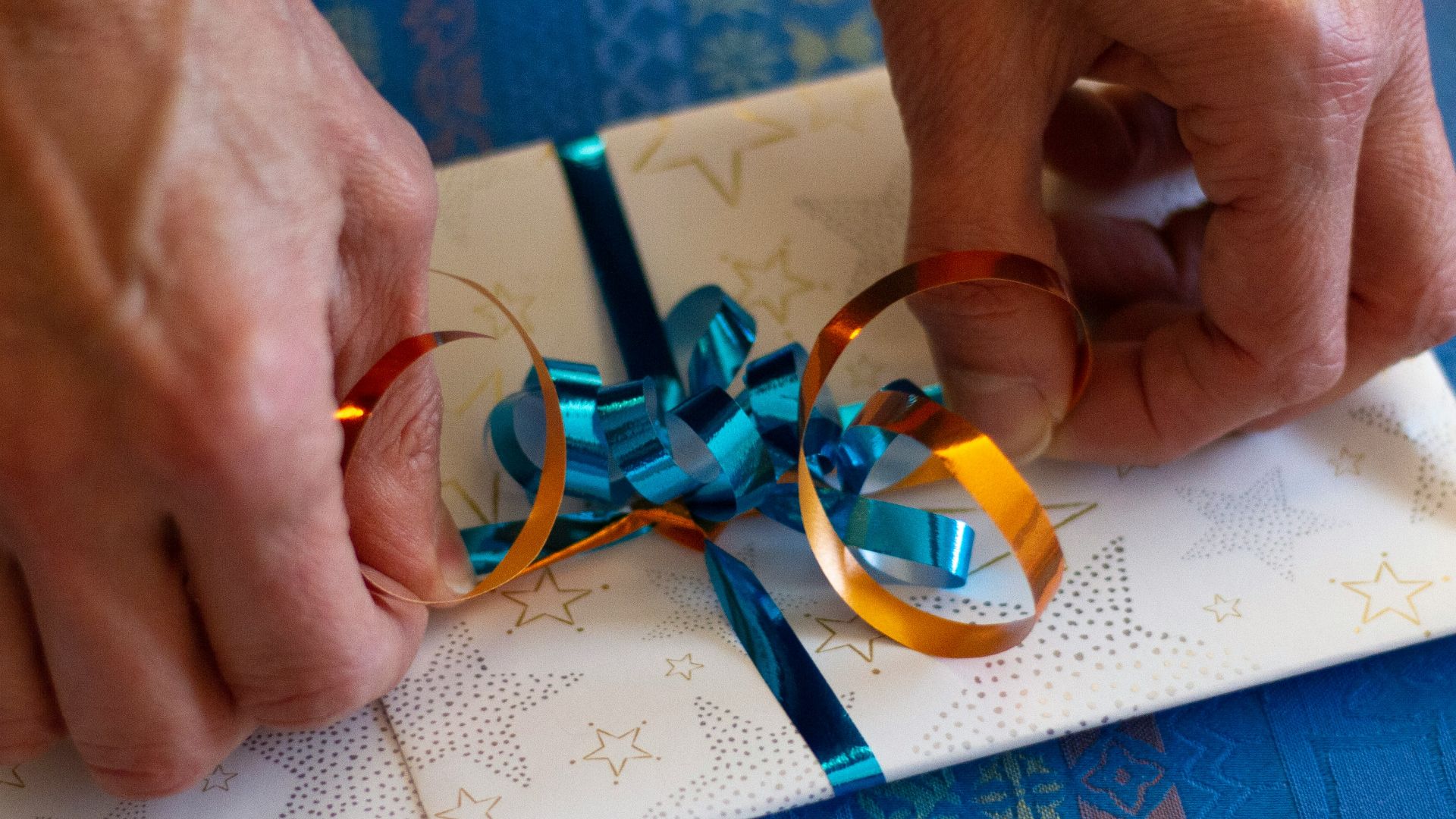 person putting ribbon on card