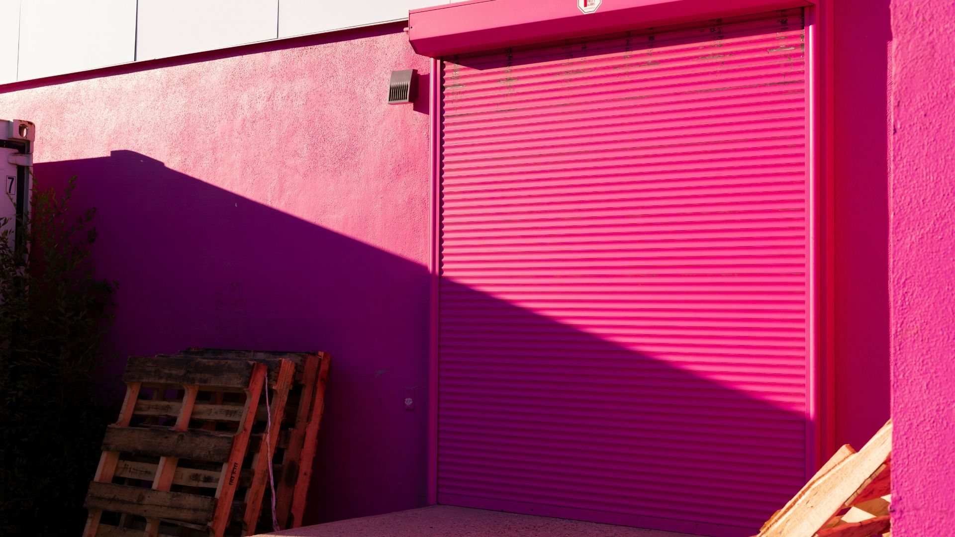 brown wooden chair beside red wall
