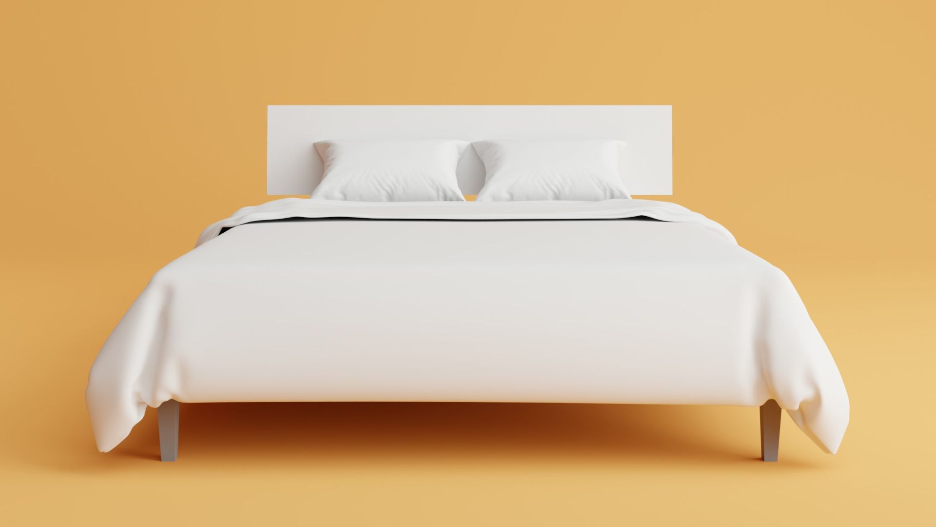 a bed with a white cover and pillows on top of it