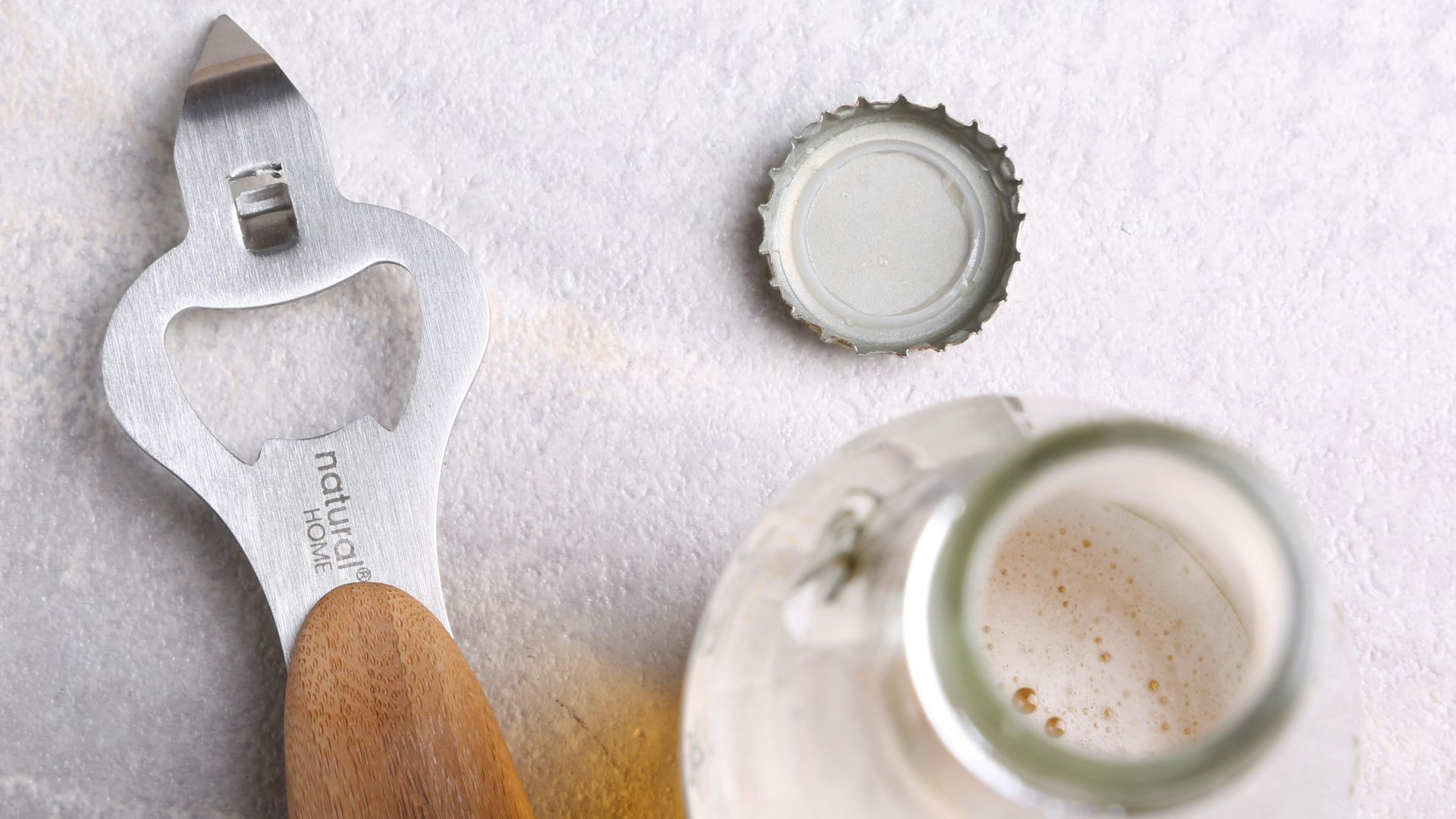 gray bottle opener beside opened bottle