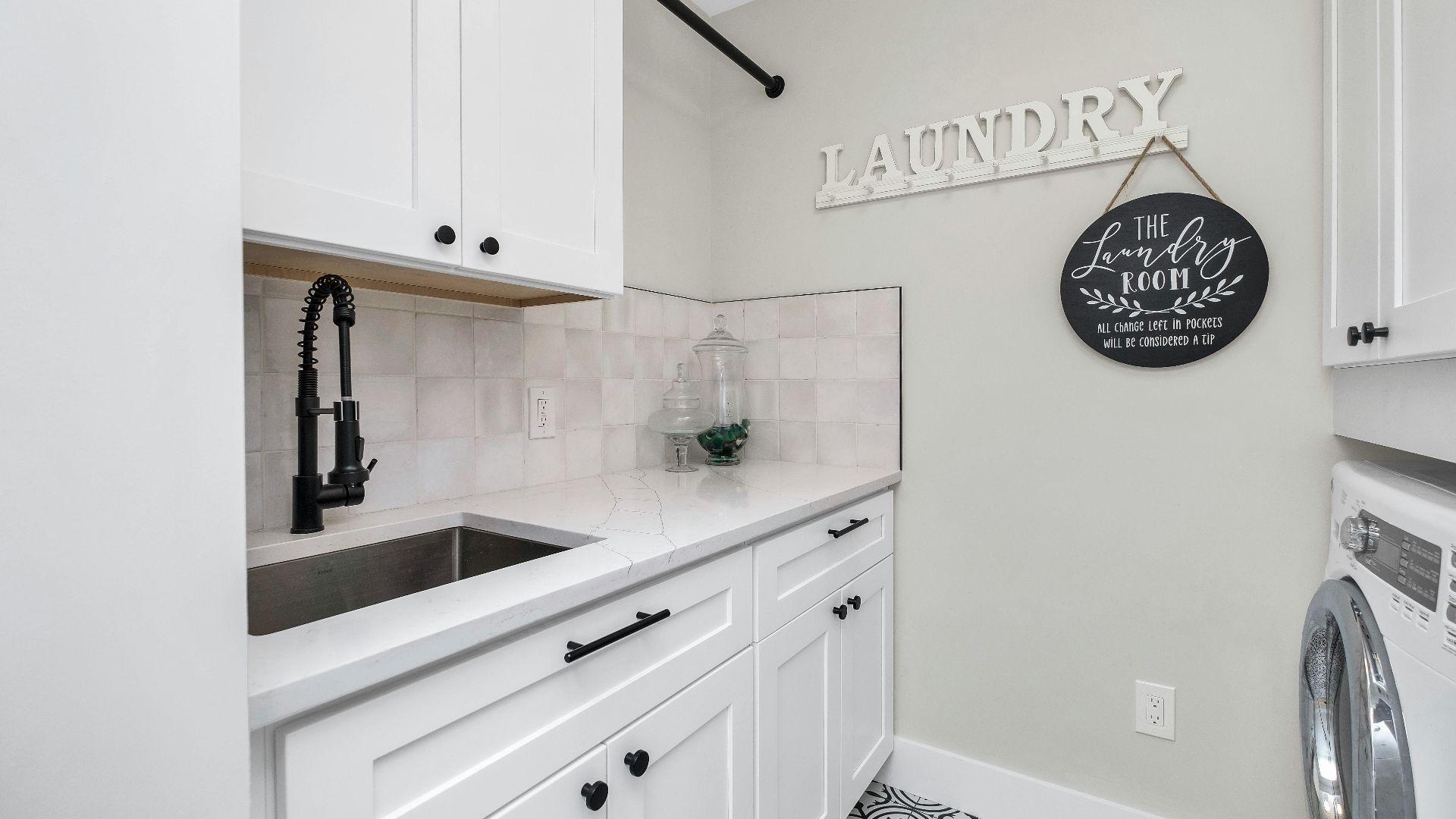 a laundry room with a sink and a washer and dryer