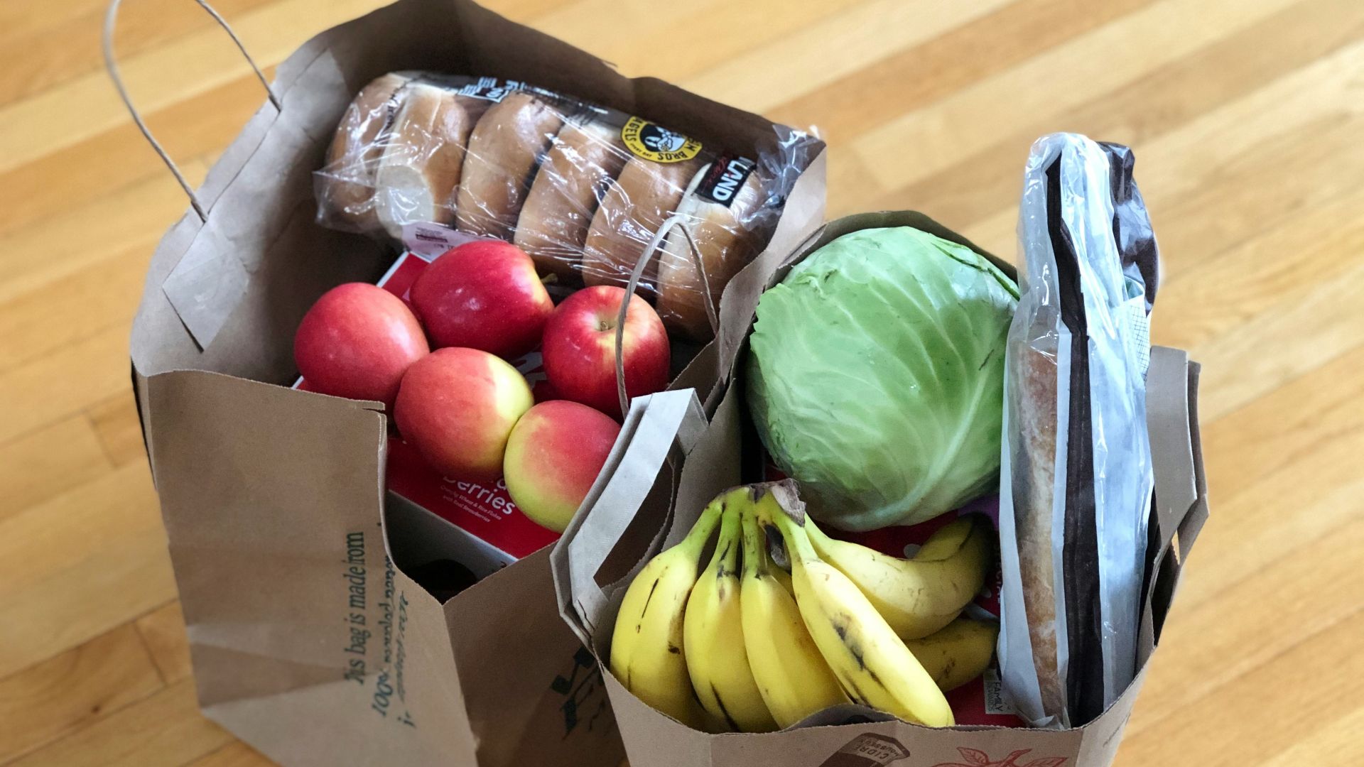apples and bananas in brown cardboard box