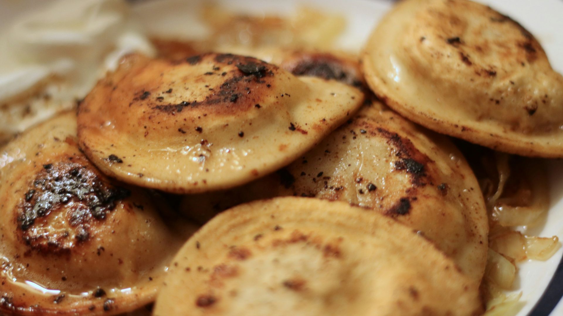 a white plate topped with potatoes and gravy