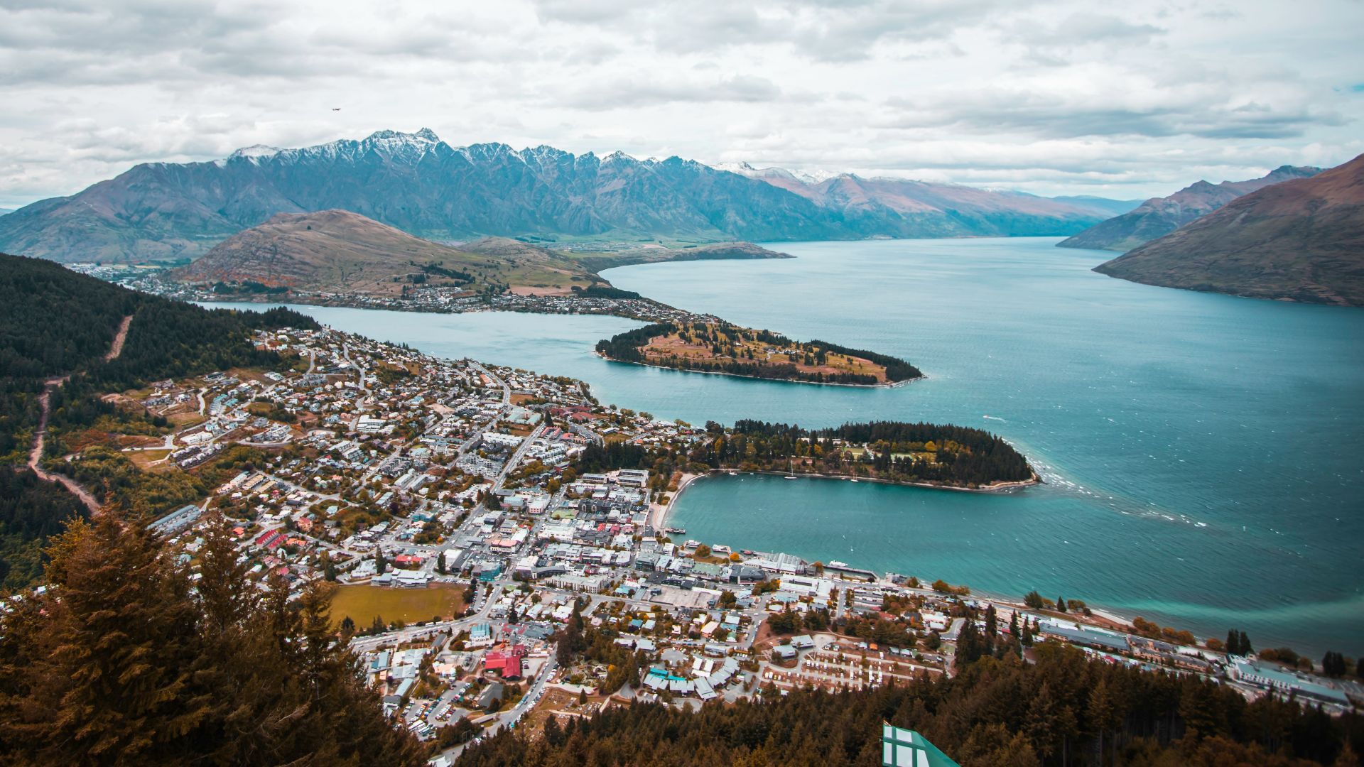 aerial photography of white houses near body of water under white clouds at daytime
