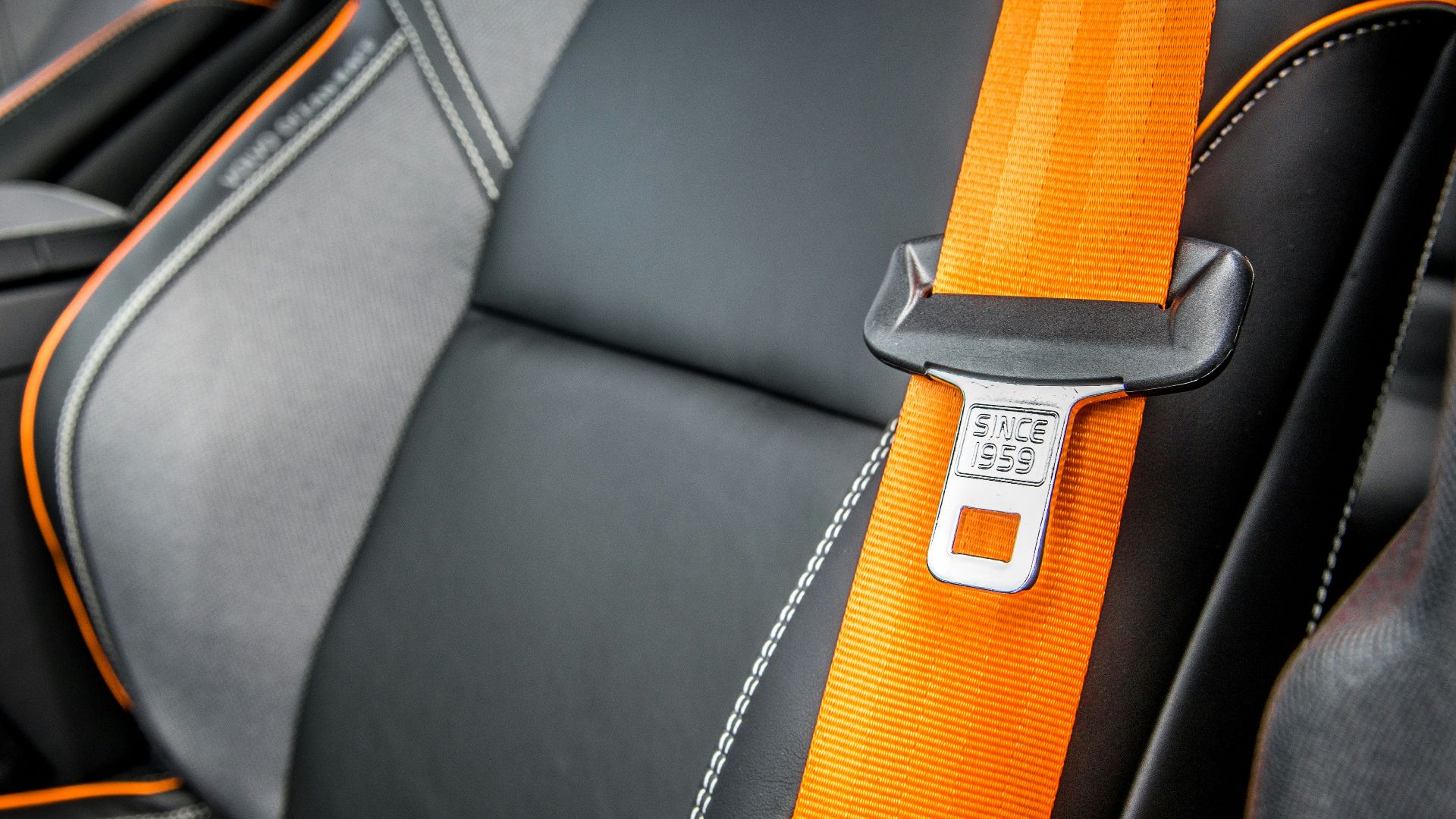 orange and white belt on black leather seat