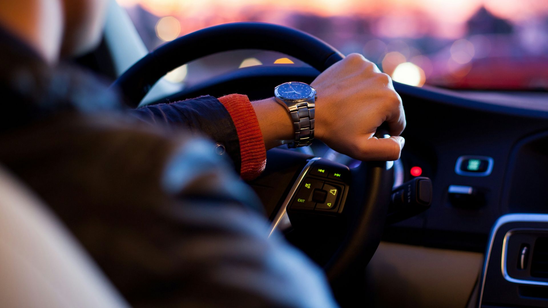 man driving a car wearing wrist watch