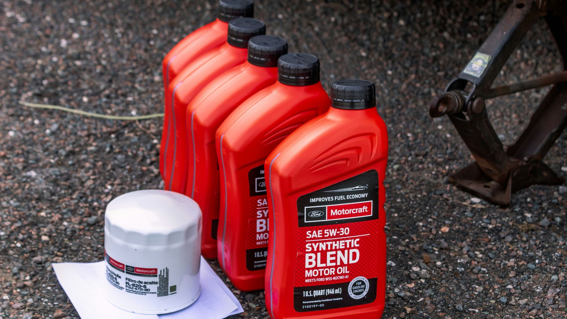 a couple of bottles of motor oil sitting on the ground