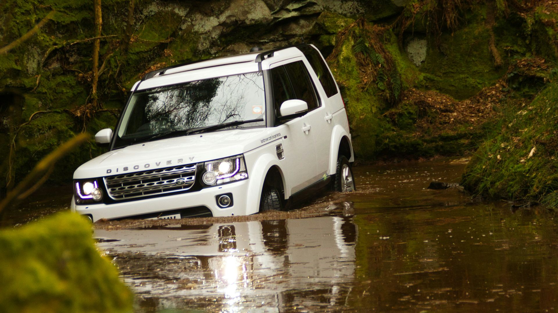 white and black suv on river