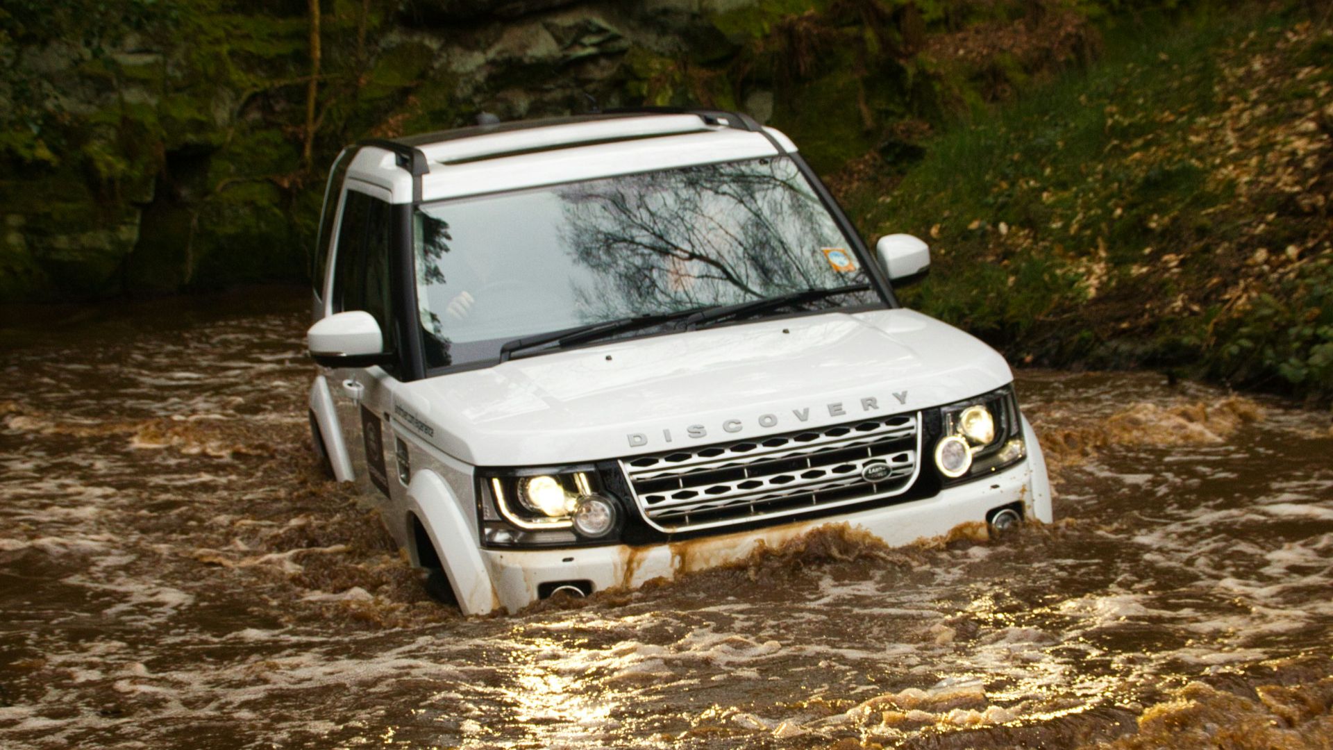 white nissan car on dirt road during daytime