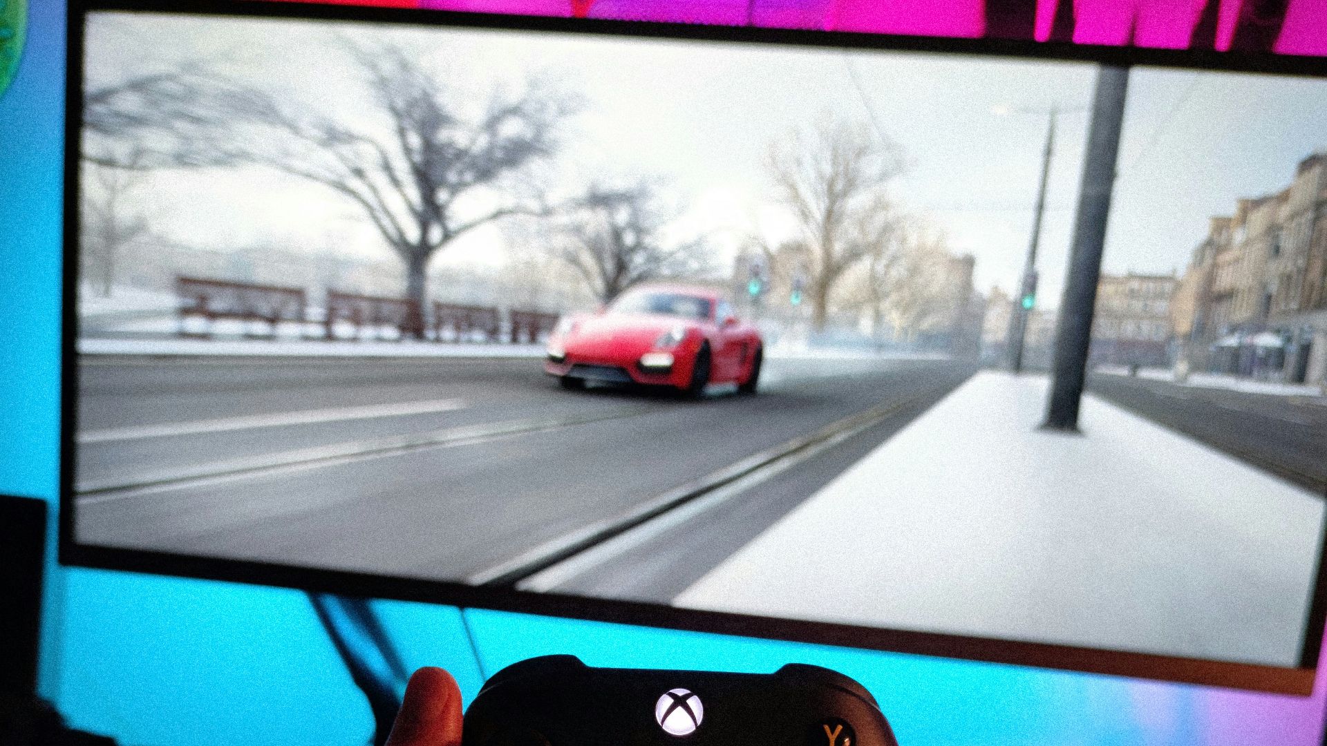 person holding black xbox one game controller