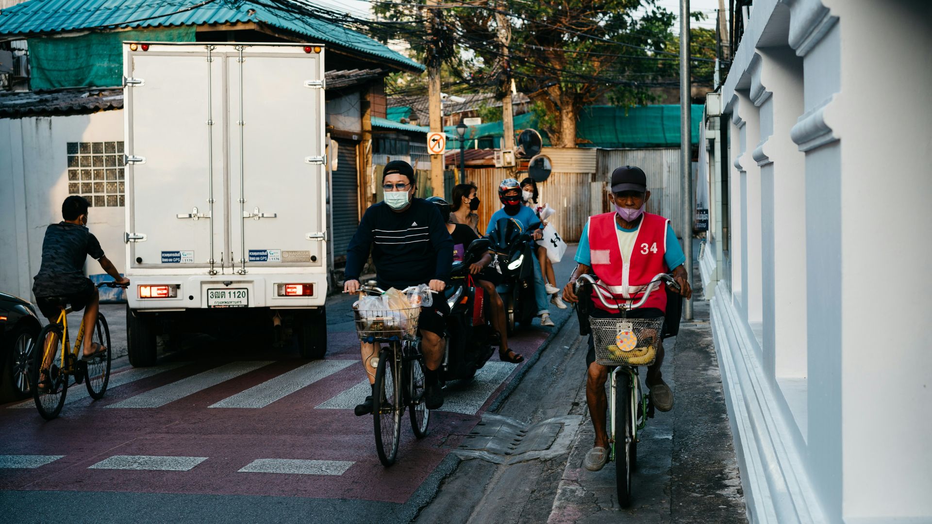 a group of people riding bikes down a street
