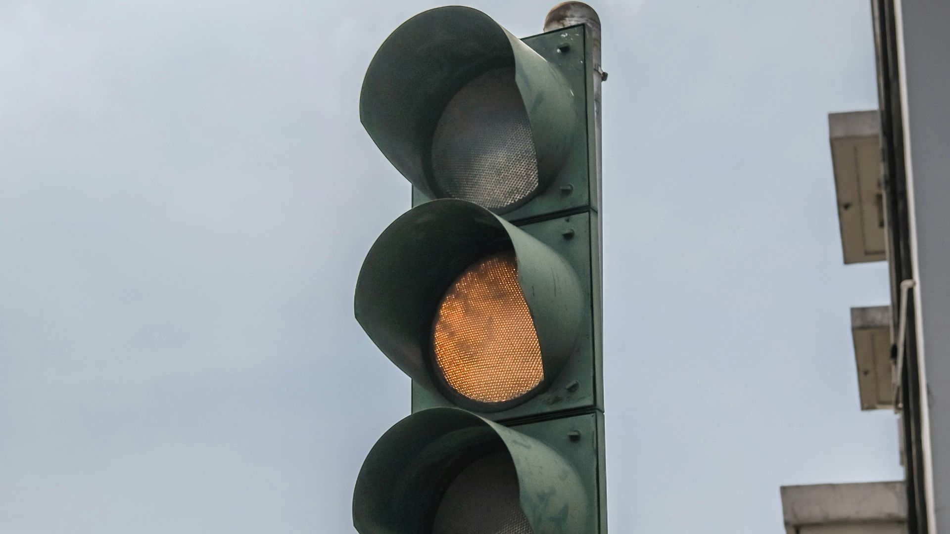 a traffic light with a building in the background